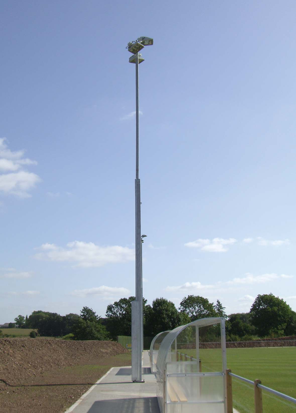 15m telescopic masts at Stone Dominoes Football Club in the UK. The local Planning department permitted a maximum permanent height of 8m.